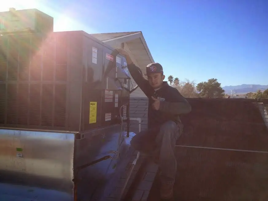 HVAC technician performing Air Duct Cleaning on a rooftop unit in Minnehaha